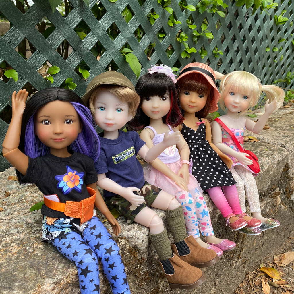 Five siblies dolls sitting and waving, all dressed in their fashionable outfits